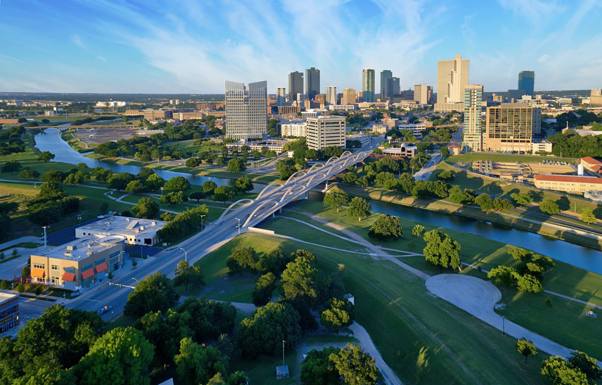 Aerial view of downtown Fort Worth, Texas, during the day with Trinity River in the foreground
